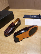 Burgundy leather loafers with tan interior and decorative heel detail