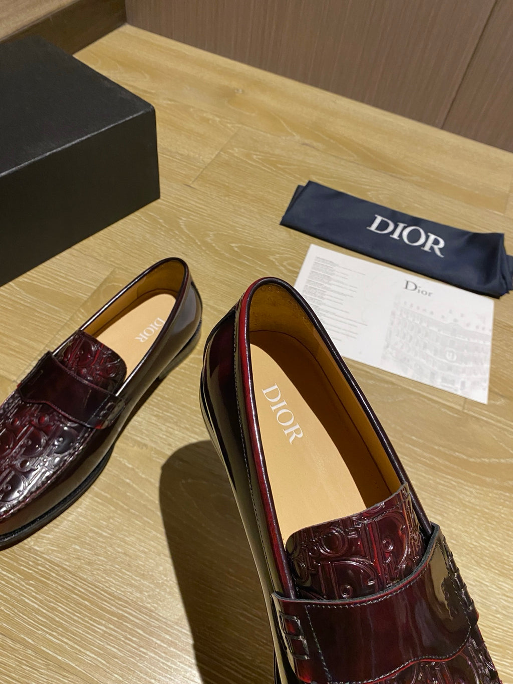 Burgundy leather slip-on loafer with embossed vamp and tan interior lining