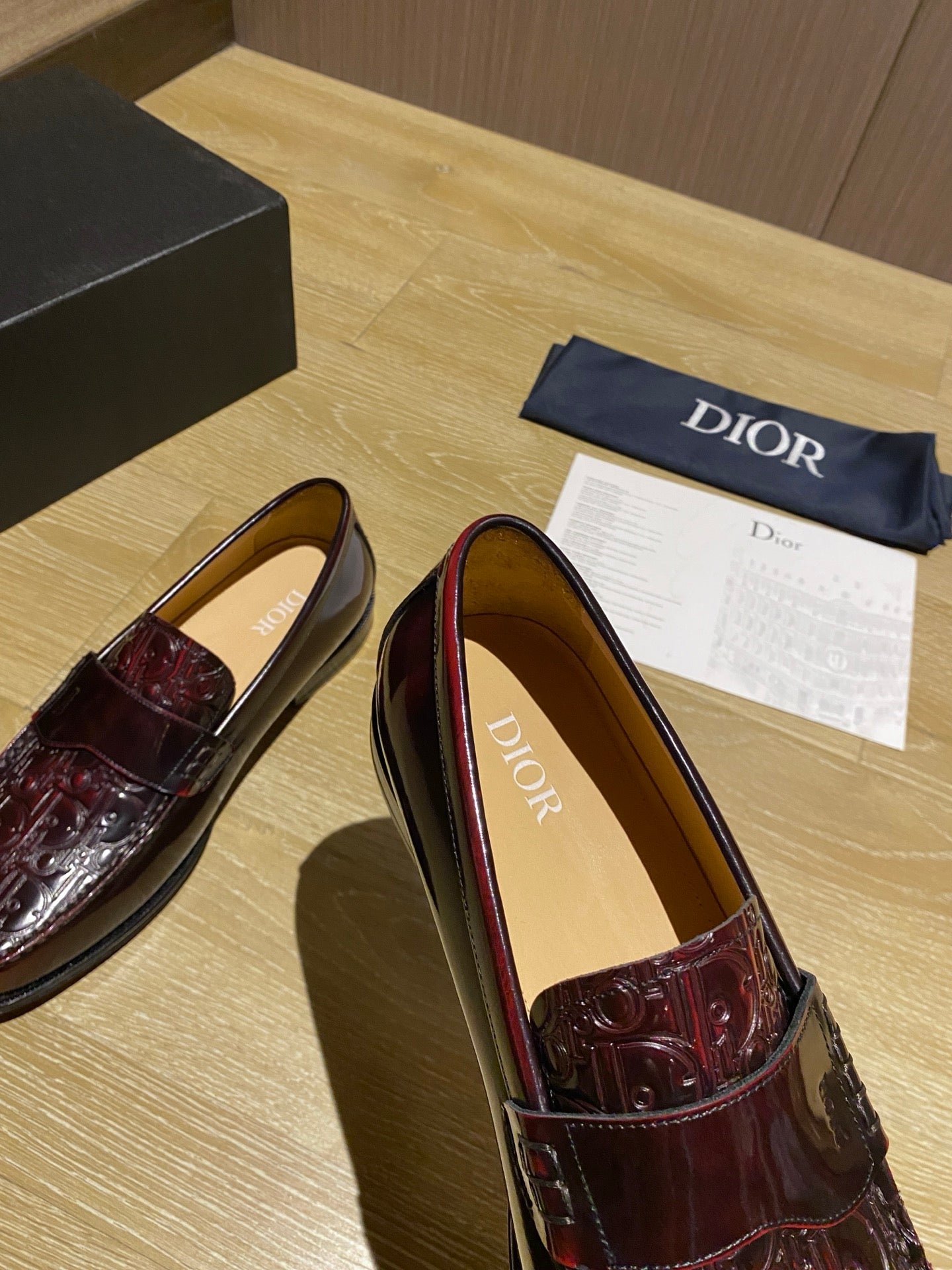 Burgundy leather slip-on loafer with embossed vamp and tan interior lining