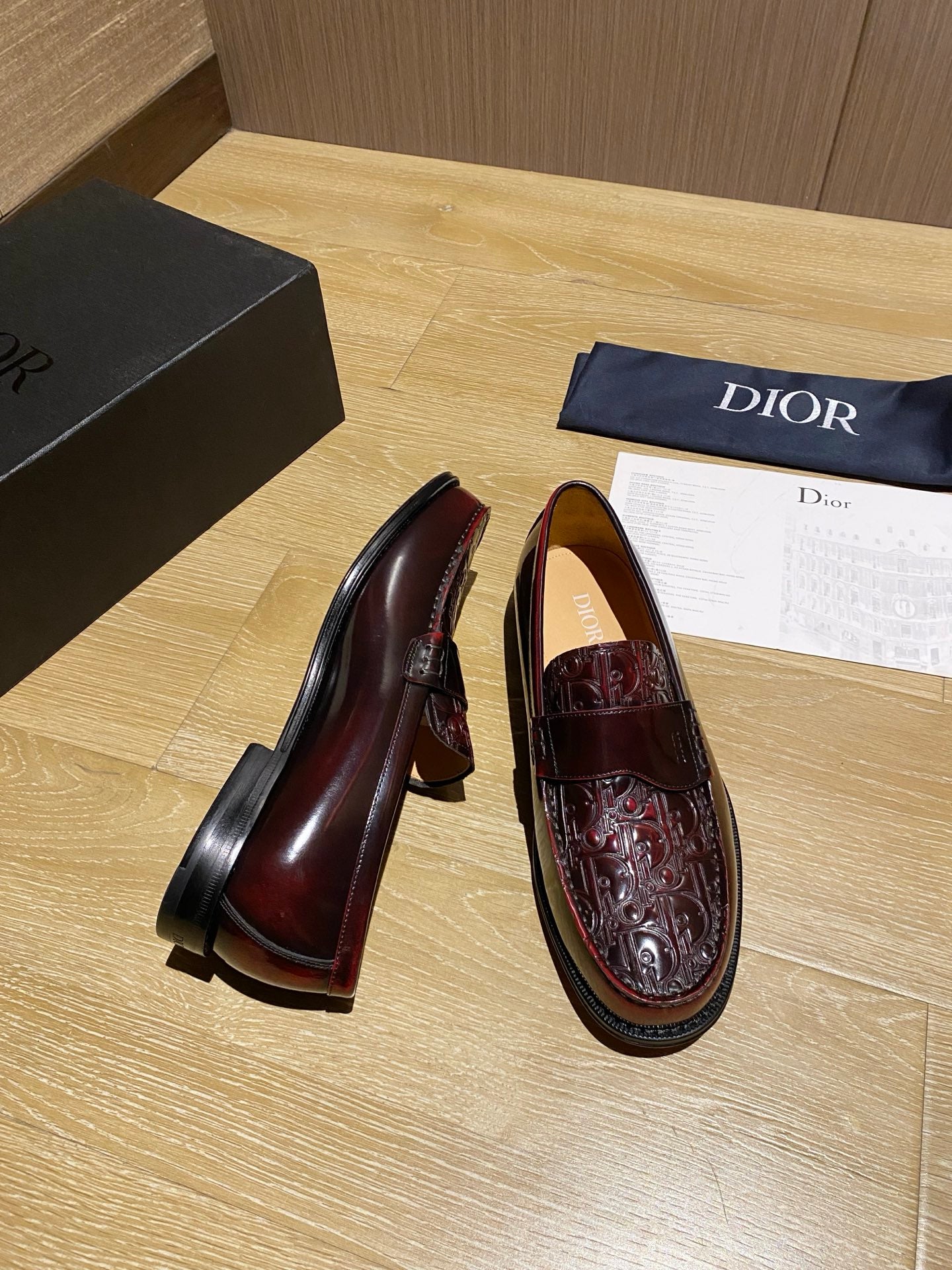 Burgundy leather loafer pair with visible heel and detailed stitched apron