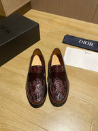 Burgundy leather unisex loafers with embossed pattern and strap detail