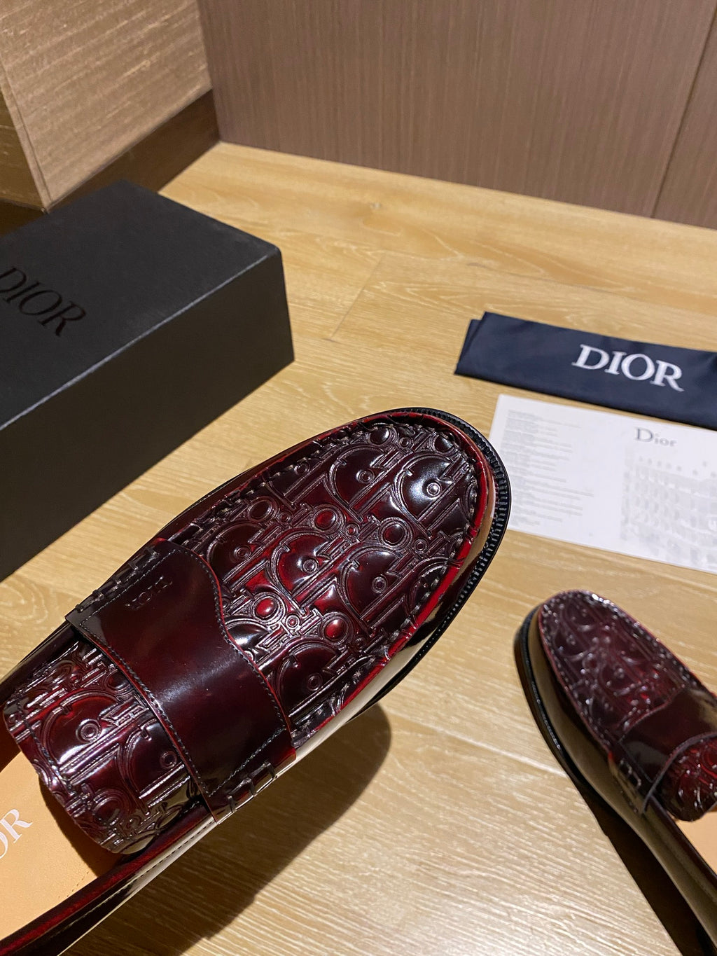 Embossed burgundy leather loafer upper with ornate stitched detailing