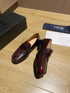 Burgundy leather slip-on loafers with strap detail and embossed vamp
