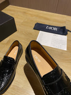 Black leather loafers, angled view, showing tan interior lining