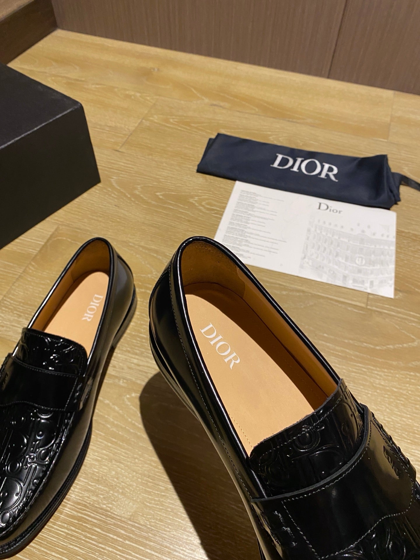 Black leather loafers, angled view, showing tan interior lining