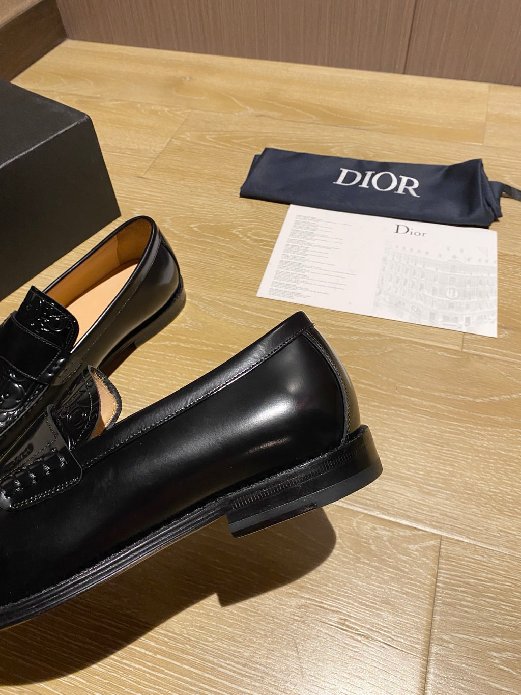 Black leather loafer with thick sole and glossy moc-toe upper