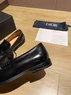 Black leather loafer with thick sole and glossy moc-toe upper
