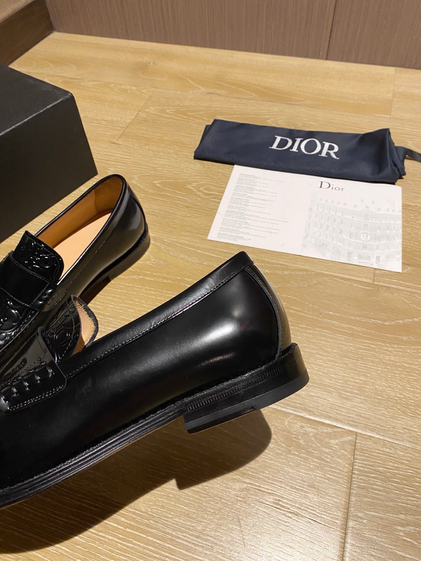 Black leather loafer with thick sole and glossy moc-toe upper
