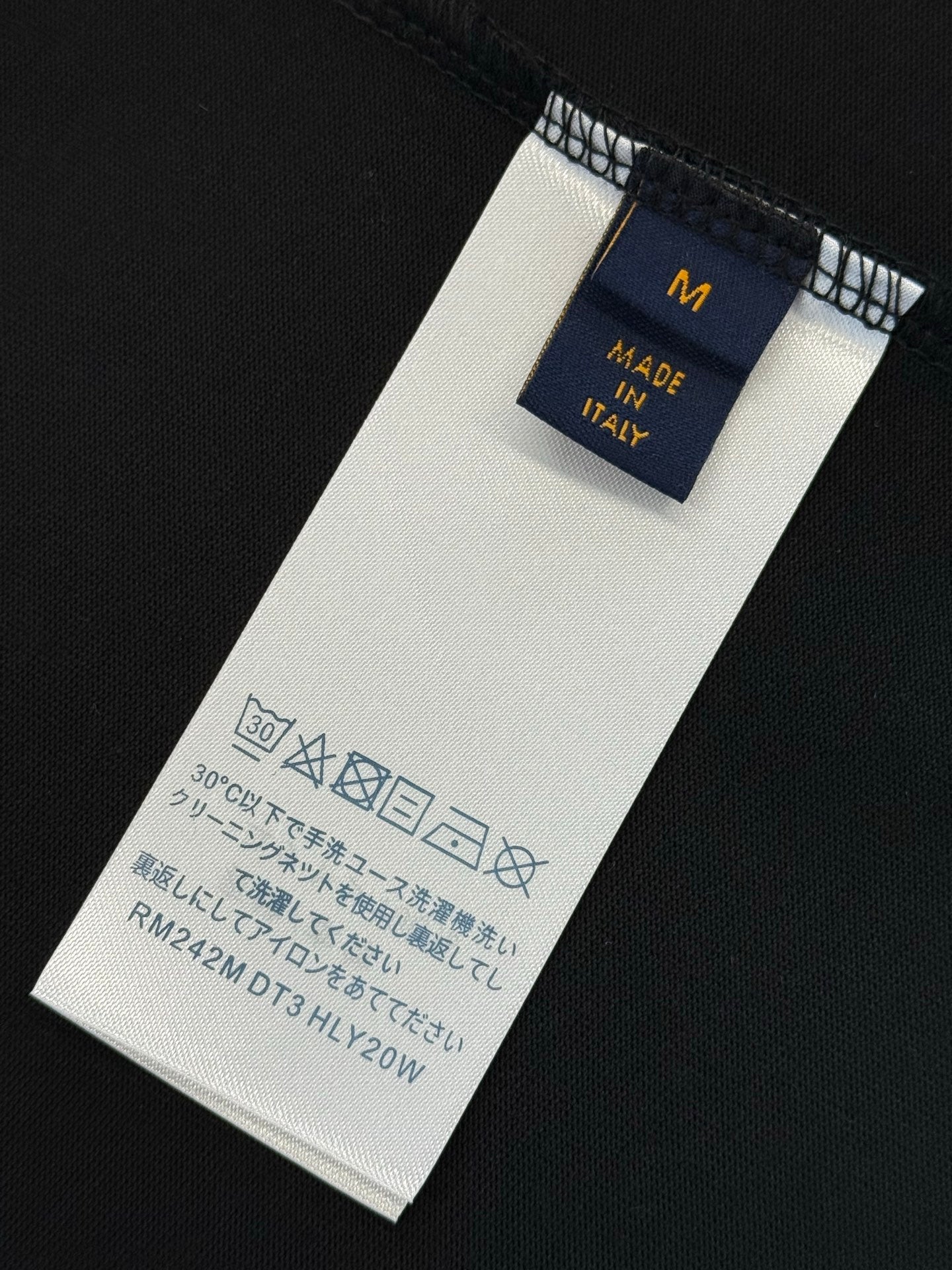 Interior size M and Made in Italy care label on black shirt