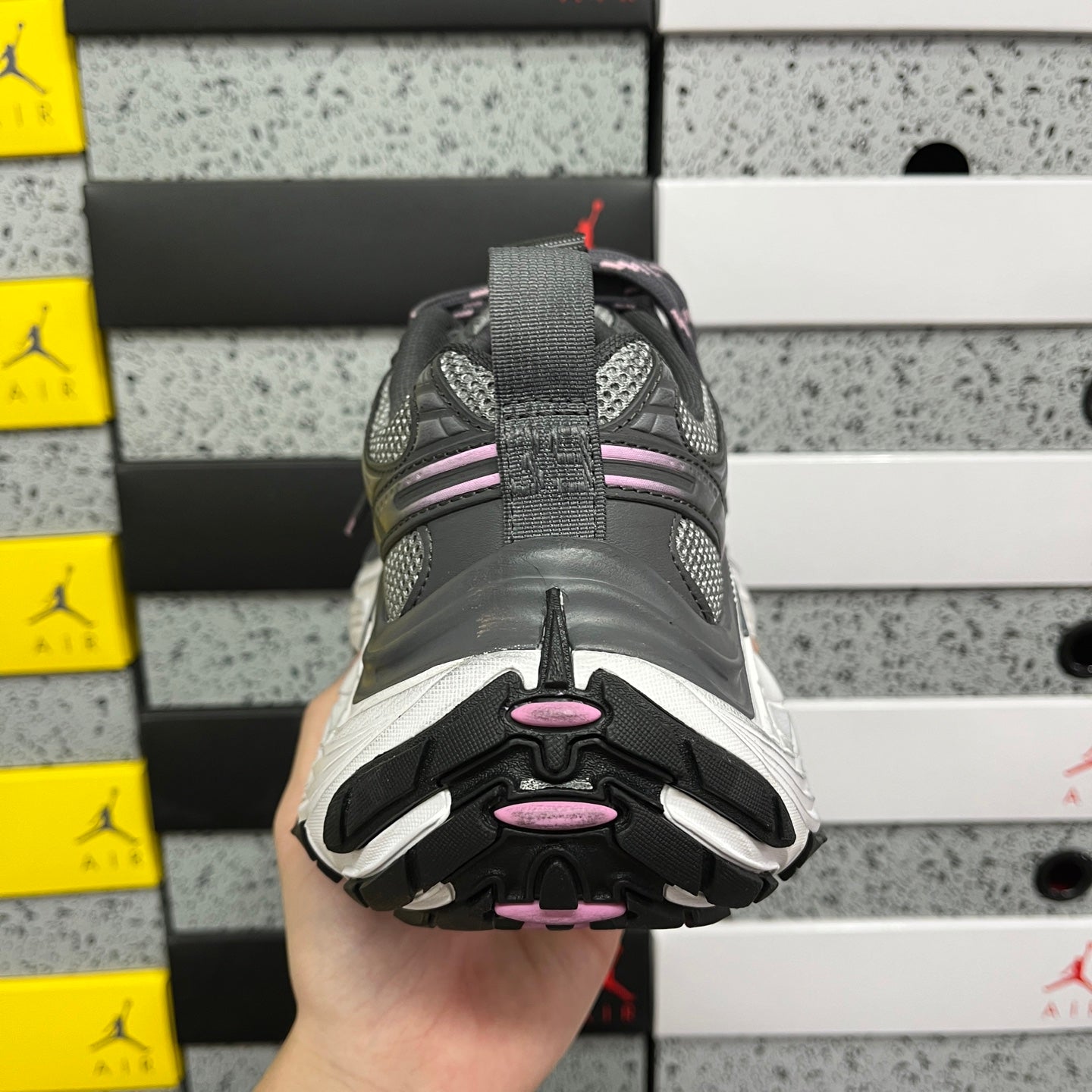 Unisex sneakers heel view with dark gray tread and white midsole edge