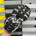 Unisex sneaker outsole in black and gray with pink accents and tread pattern