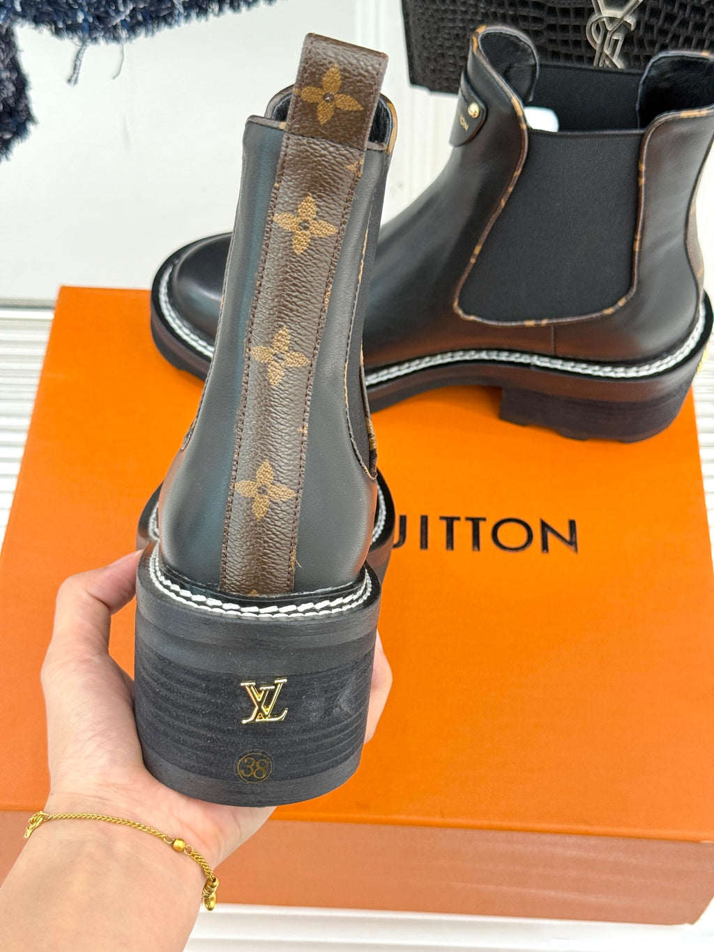 Louis Vuitton black chelsea boots with monogram heel patch and elastic side gore