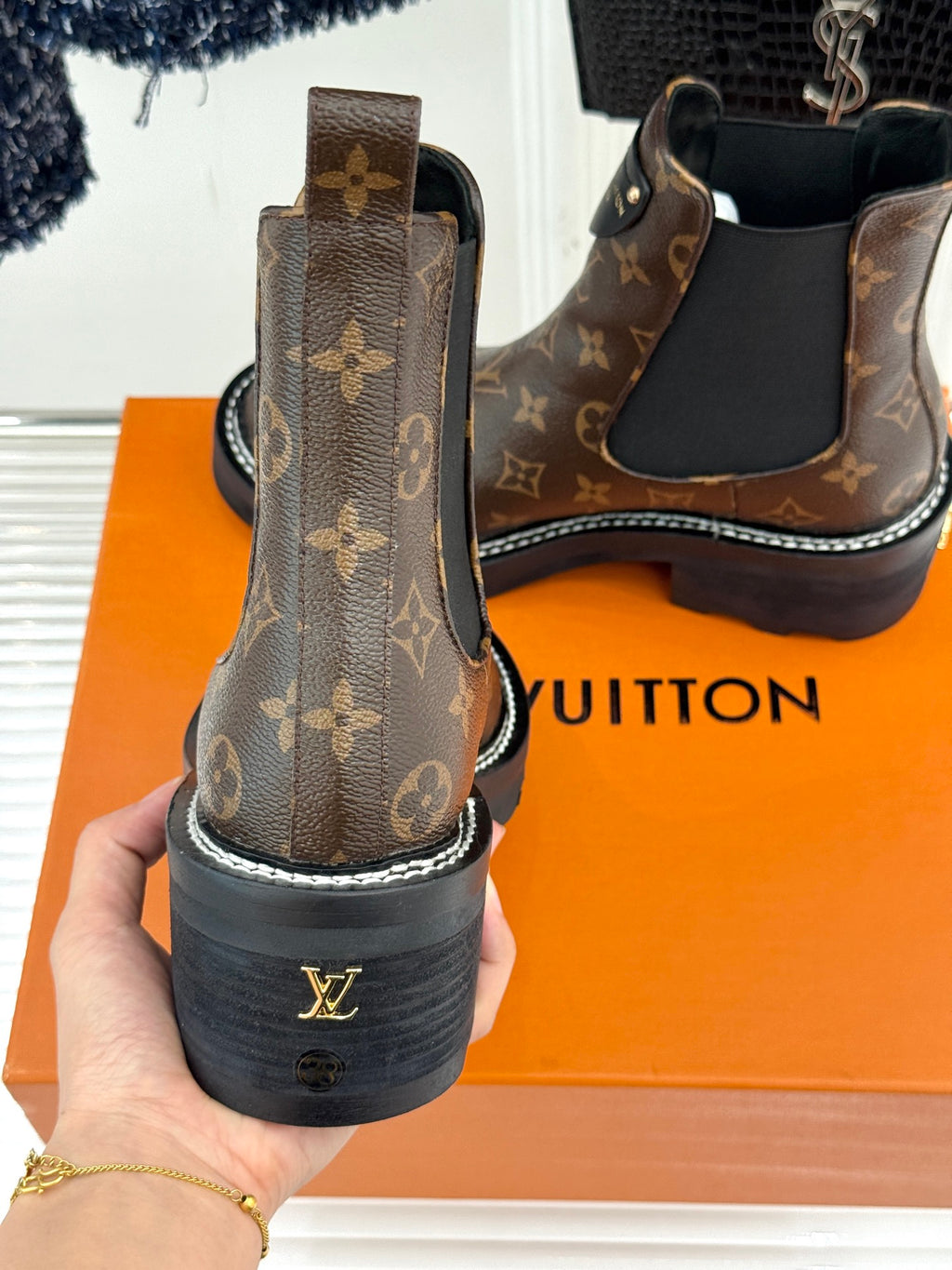 Louis Vuitton monogram chelsea boot heel back view held in hand, chunky sole