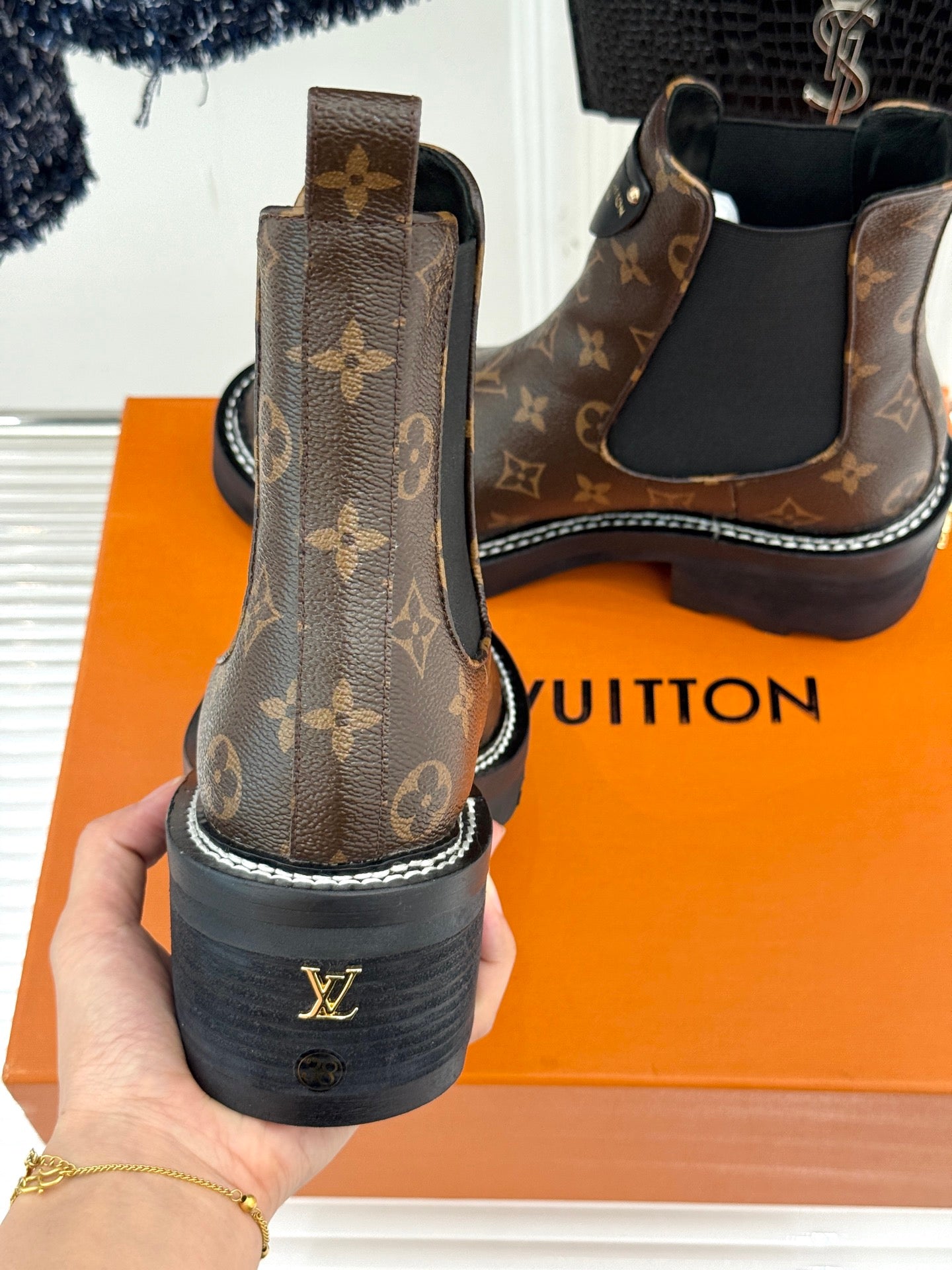 Louis Vuitton monogram chelsea boot heel back view held in hand, chunky sole