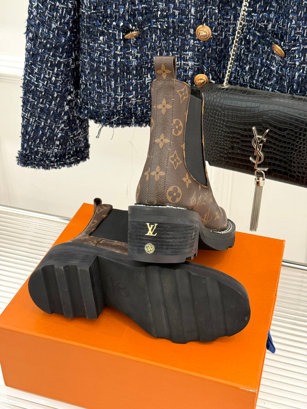 Louis Vuitton monogram chelsea boots showing outsole tread on orange box