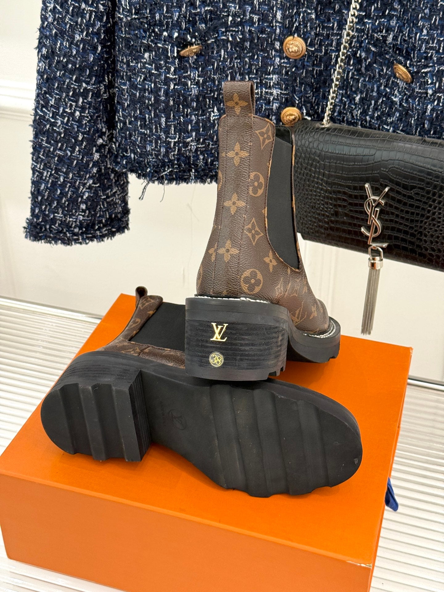 Louis Vuitton monogram chelsea boots showing outsole tread on orange box