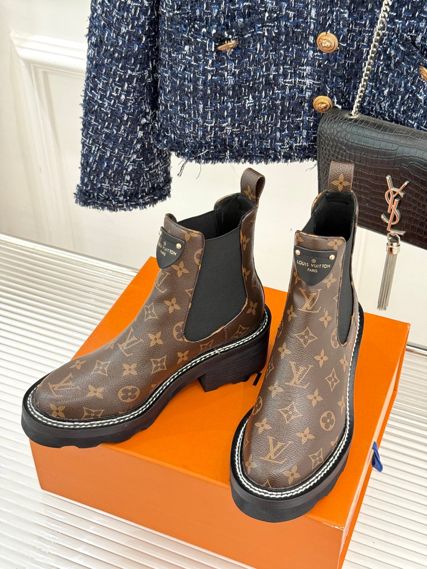 Louis Vuitton monogram chelsea boots with black elastic gore, side view on orange box