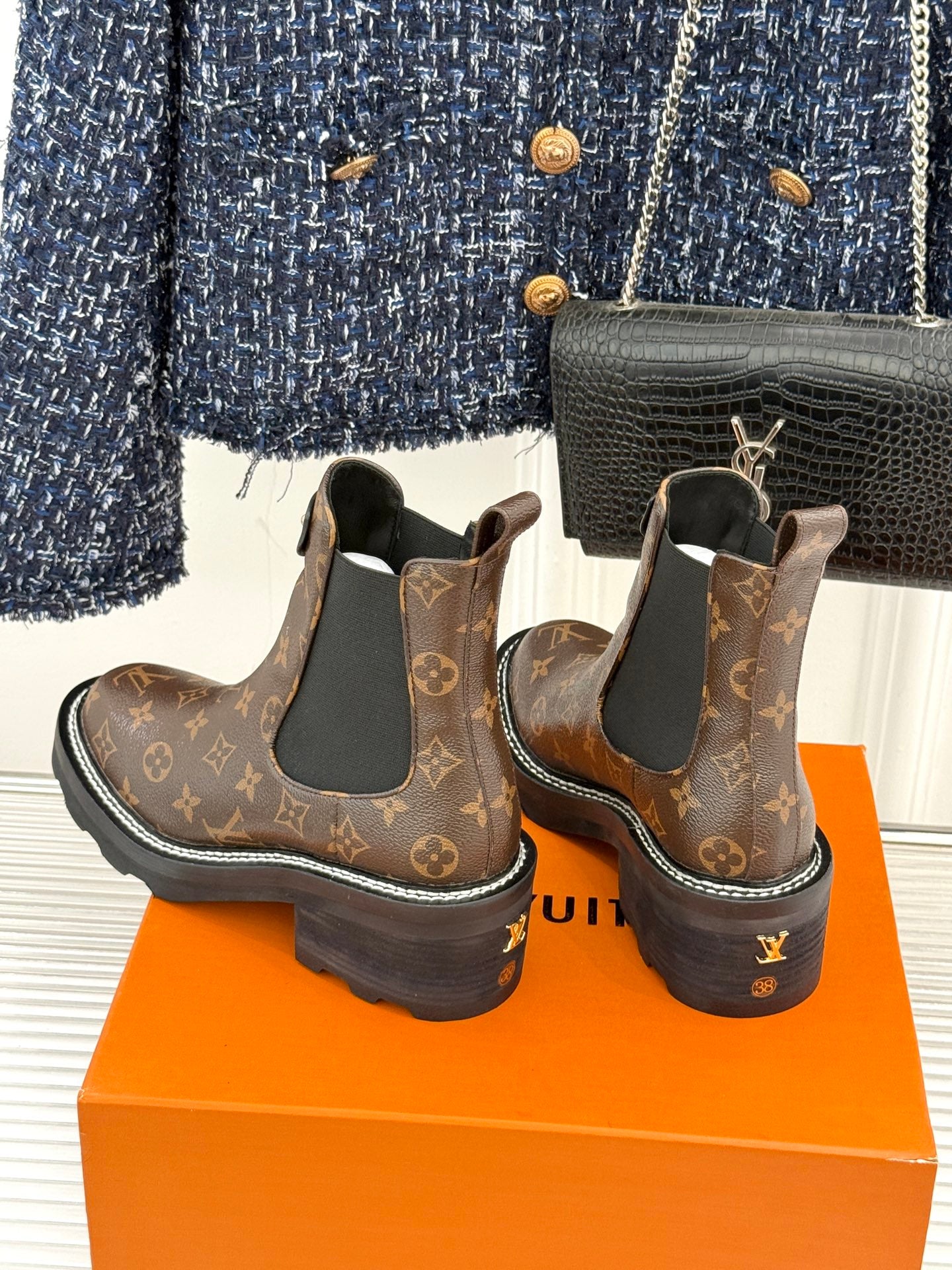 Louis Vuitton monogram chelsea boots with black elastic panels and white edge stitching