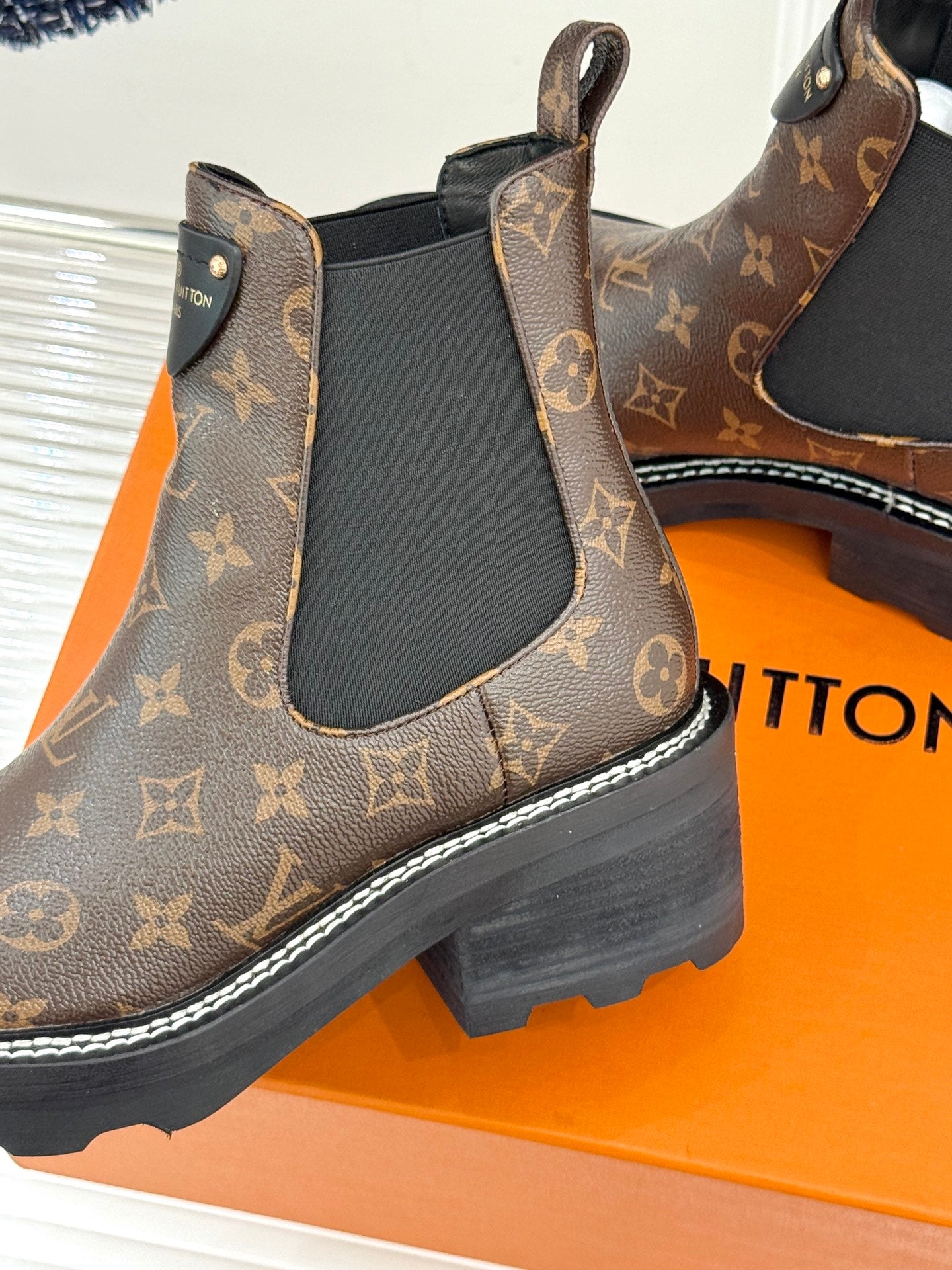 Louis Vuitton monogram chelsea boot close-up with black elastic gore and chunky sole