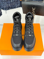 Black lace-up mid-top boots with padded tongue and thick tread sole