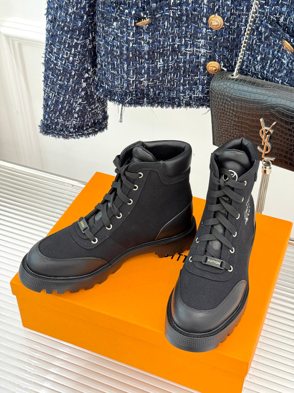Black mid-top lace-up boot pair with cushioned collar and chunky platform sole