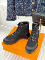 Black mid-top lace-up boot pair with cushioned collar and chunky platform sole
