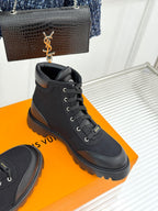 Black mid-top lace-up boot with chunky sole and rear pull tab