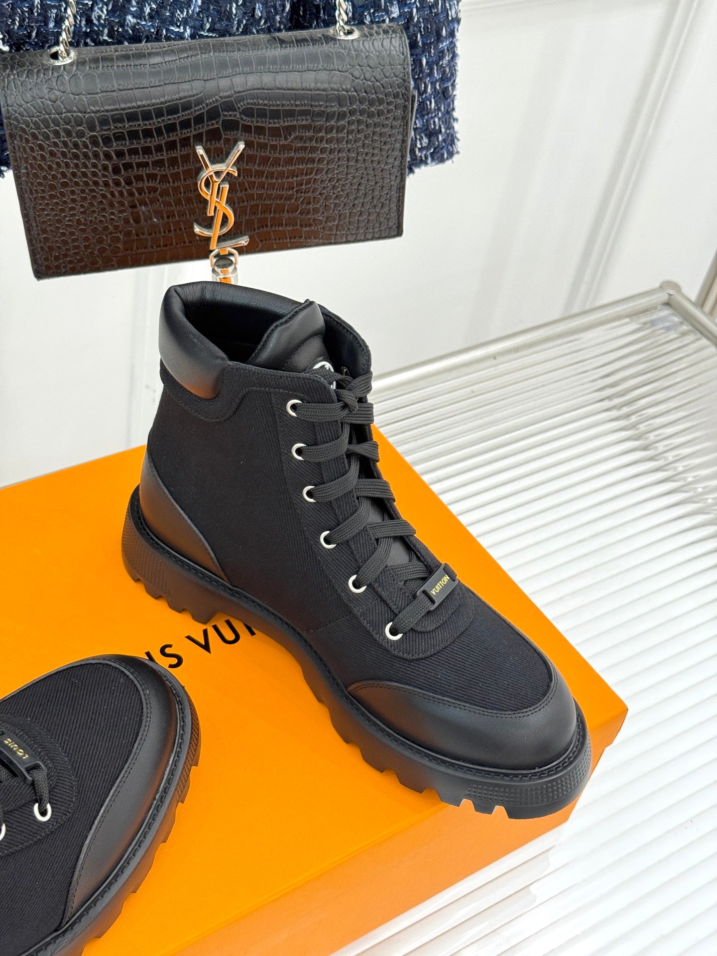 Black mid-top lace-up boot with chunky sole and rear pull tab