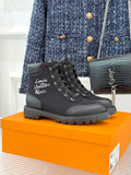 Black mid-top lace-up boot with thick rubber sole and round toe