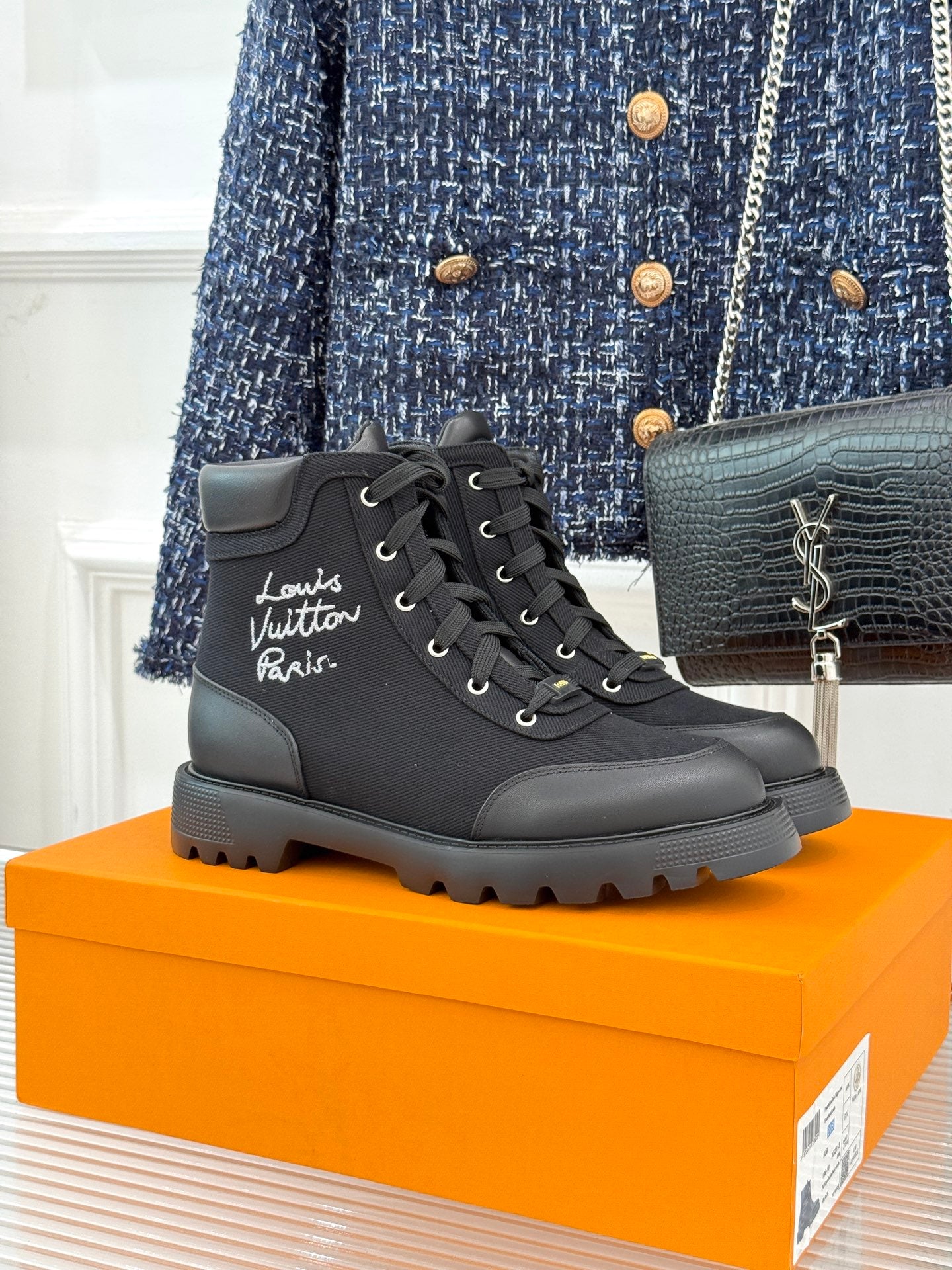 Black mid-top lace-up boot with thick rubber sole and round toe