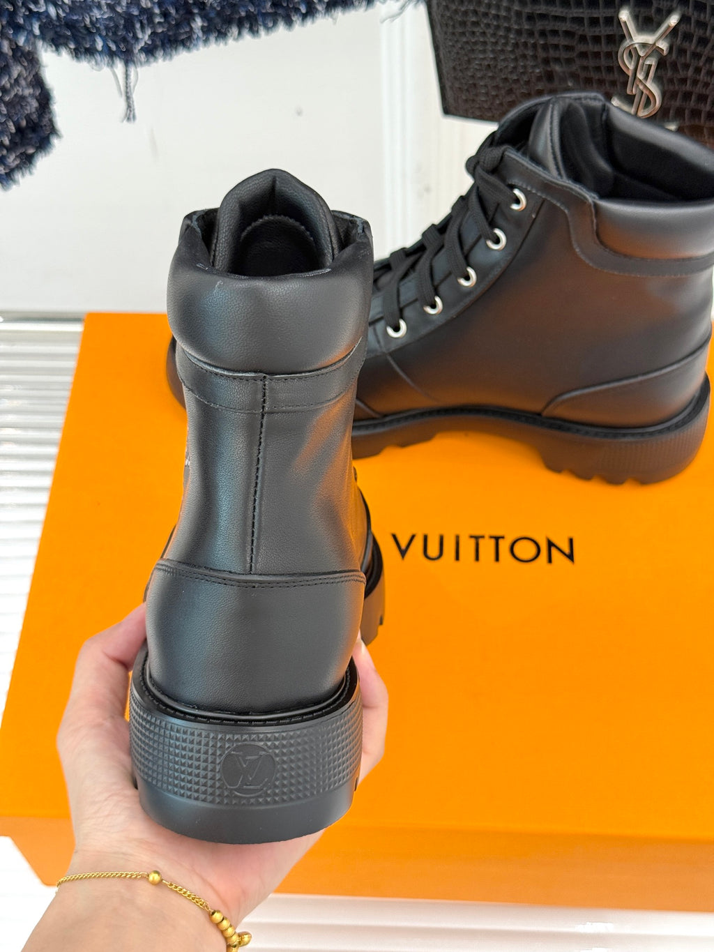 Black leather lace-up boot heel and back collar view