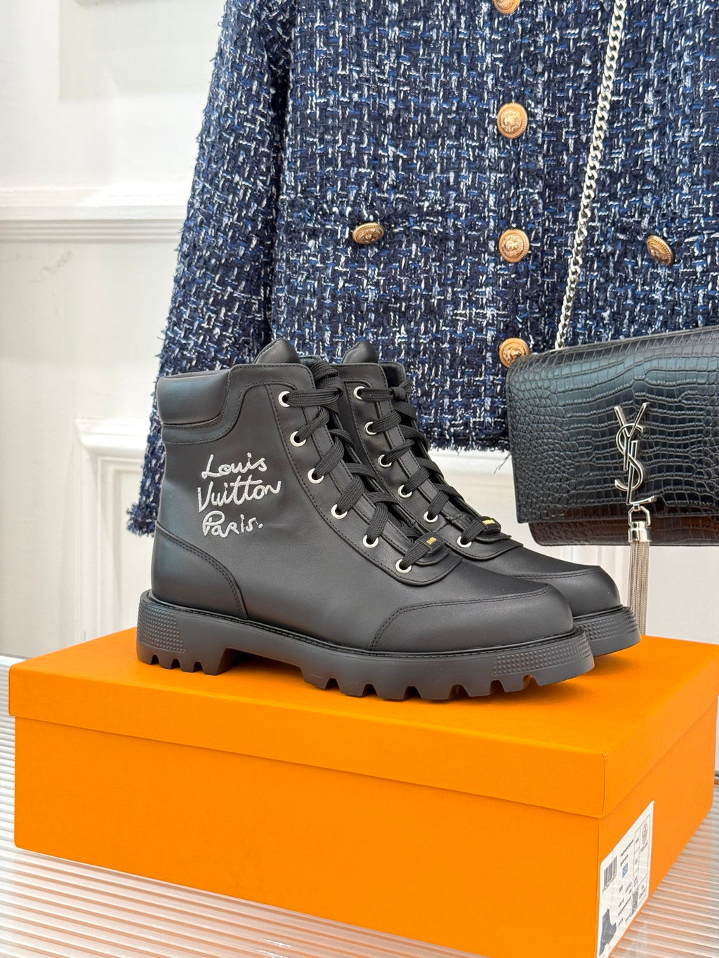 Black leather lace-up ankle boot with logo on side and chunky rubber sole