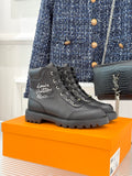 Black leather lace-up ankle boot with logo on side and chunky rubber sole