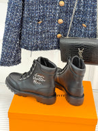 Black lace-up ankle boots with 'Louis Vuitton Paris' script on the side