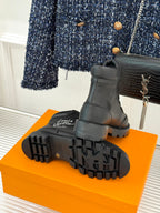 Black boot outsole with rugged tread and thick rubber platform