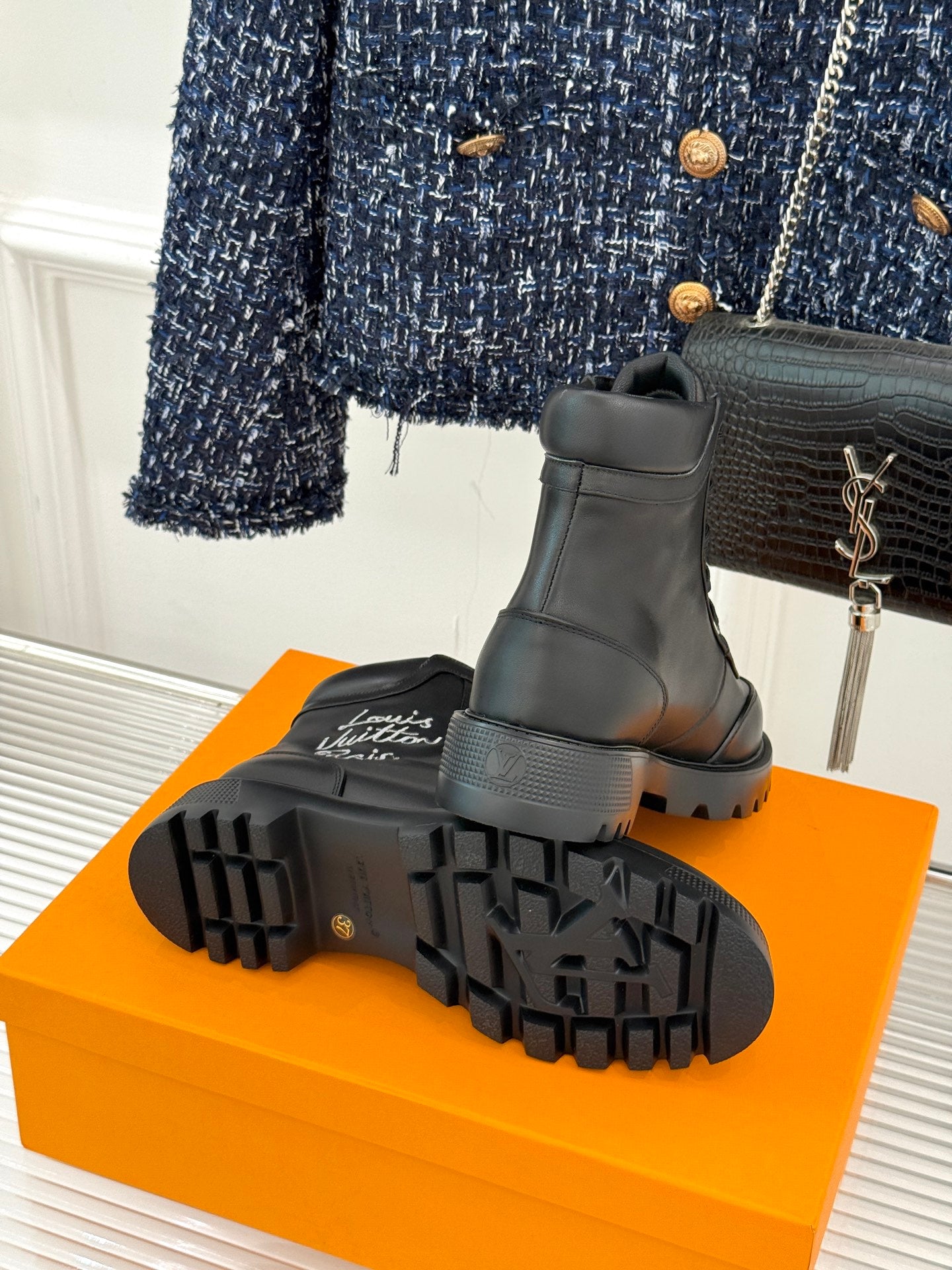 Black boot outsole with rugged tread and thick rubber platform