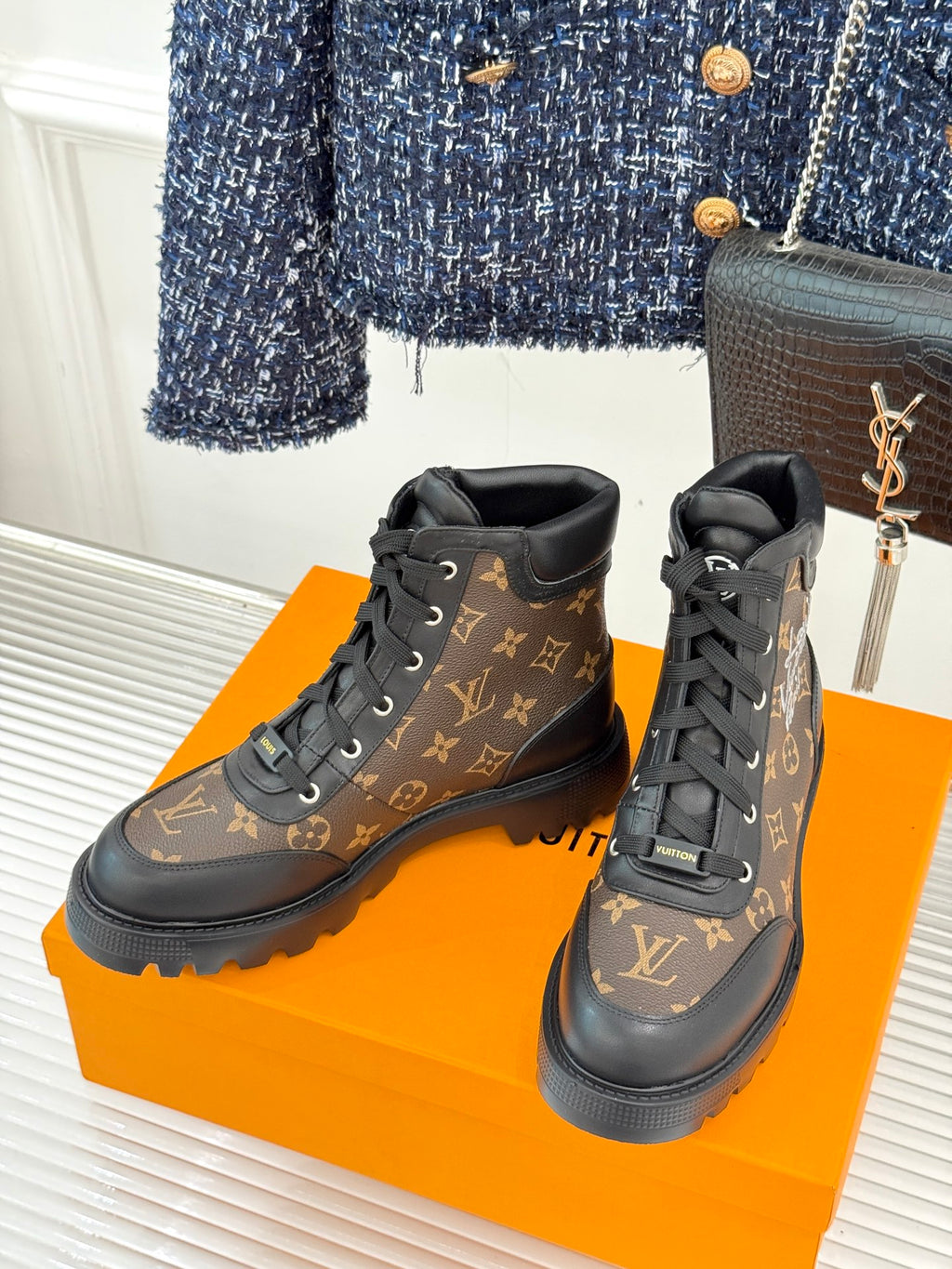 Monogram lace-up boots with black laces and dark brown leather upper