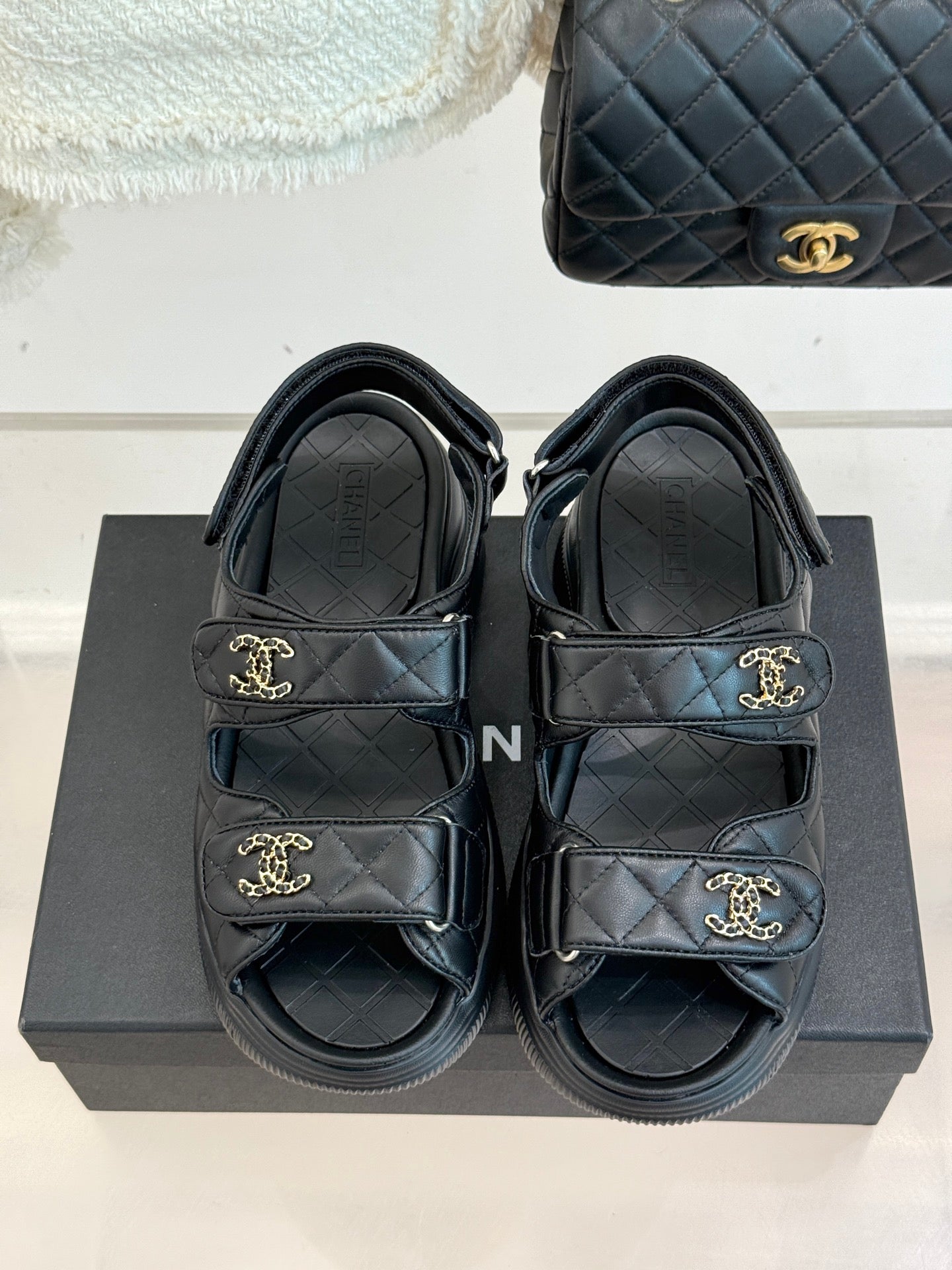 Chanel dark slide sandals, quilted footbed straps with gold CC emblems