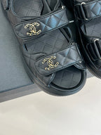 Chanel dark quilted slide sandals with gold CC emblem on each strap
