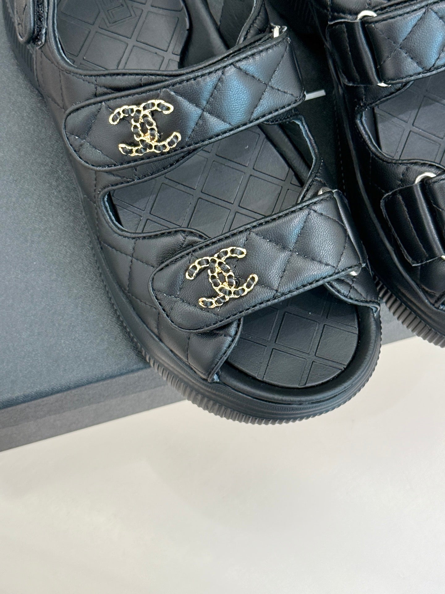 Chanel dark quilted slide sandals with gold CC emblem on each strap