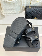 Chanel dark platform slide sandals with textured outsole and quilted straps