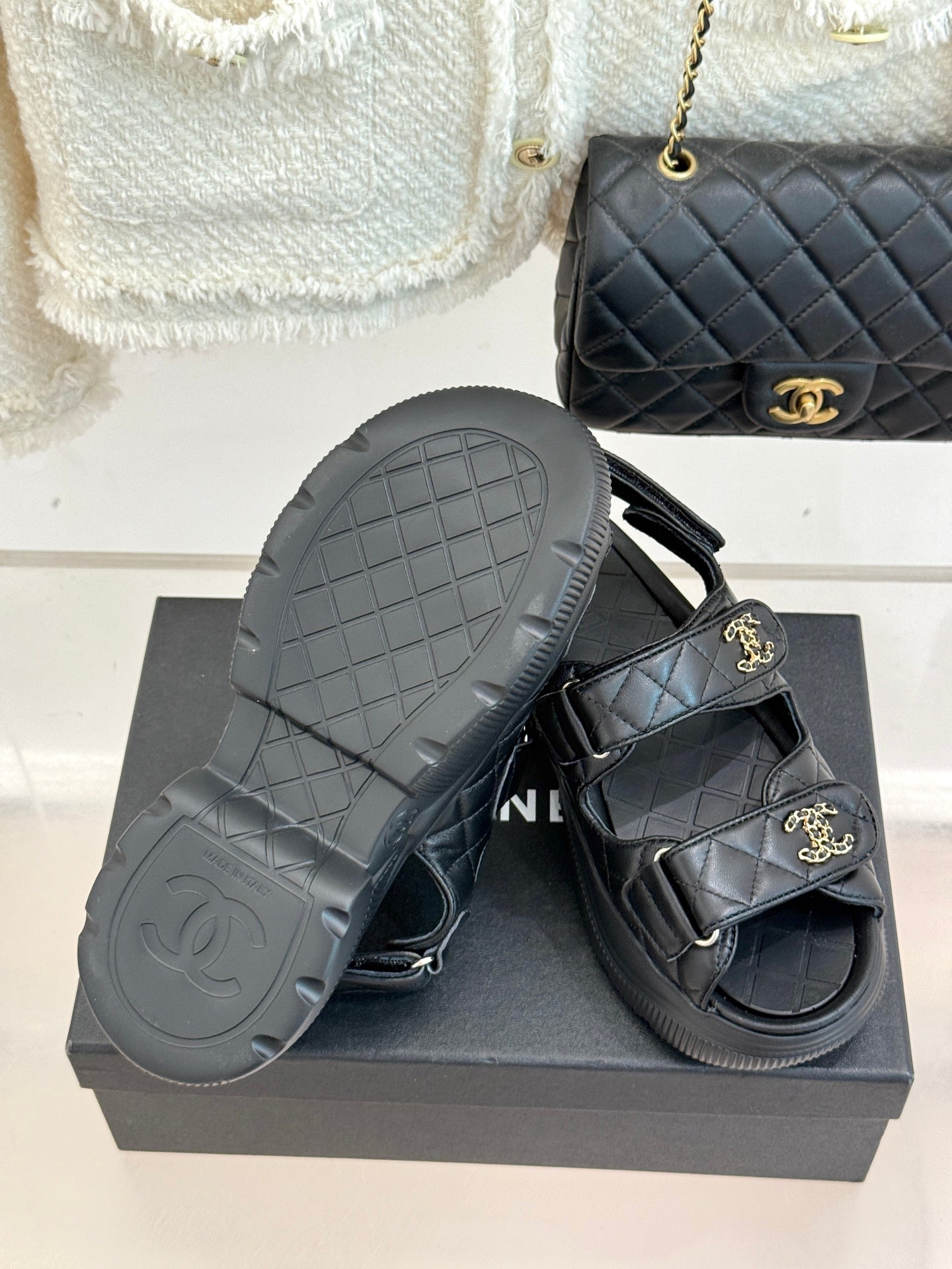 Chanel dark platform slide sandals with textured outsole and quilted straps