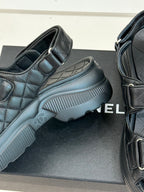 Chanel dark platform slide sandal showing textured sole and quilted strap