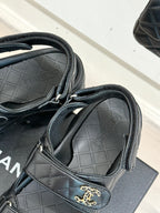 Chanel dark slide sandal showing quilted strap detail and molded footbed