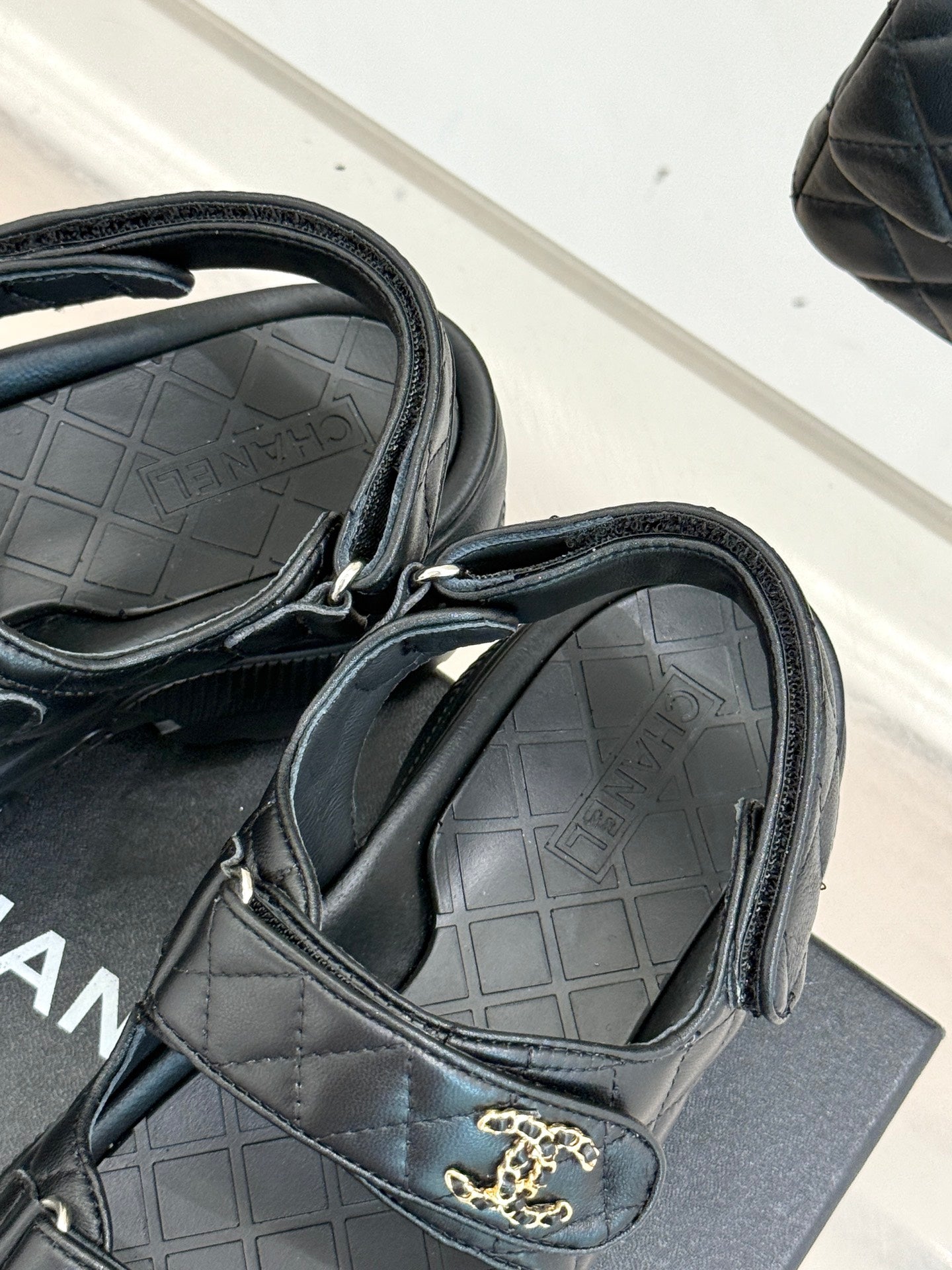 Chanel dark slide sandal showing quilted strap detail and molded footbed