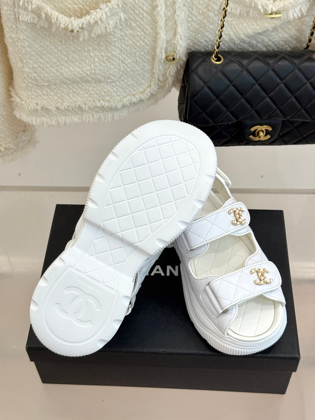 Chanel ladies white leather sandals with gold logo buckles and patterned outsole