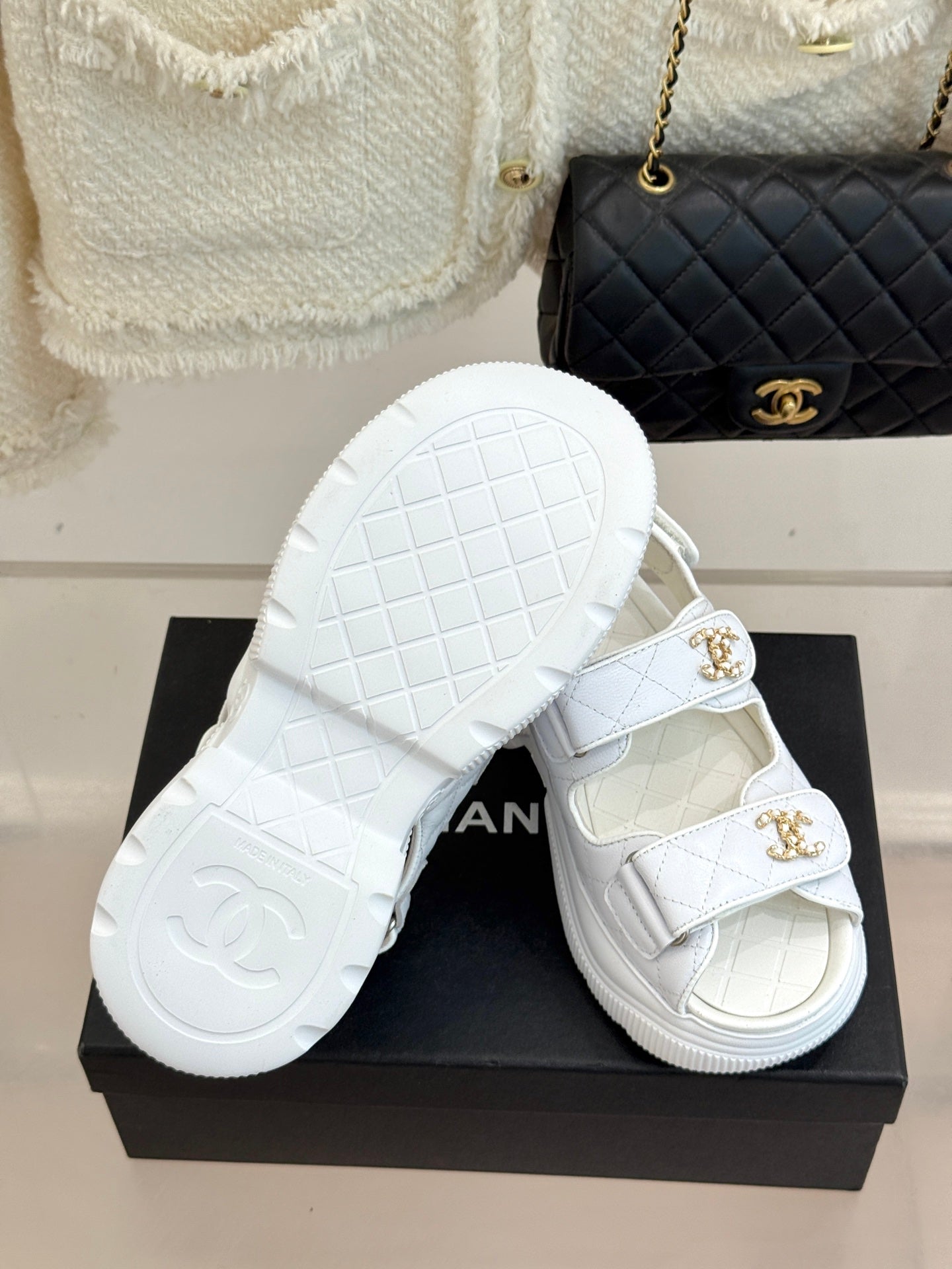 Chanel ladies white leather sandals with gold logo buckles and patterned outsole