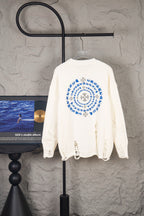 White long-sleeve knit sweater with large back circular blue graphic