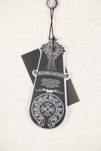 White knit sweater front tag graphic with ornate crest and text