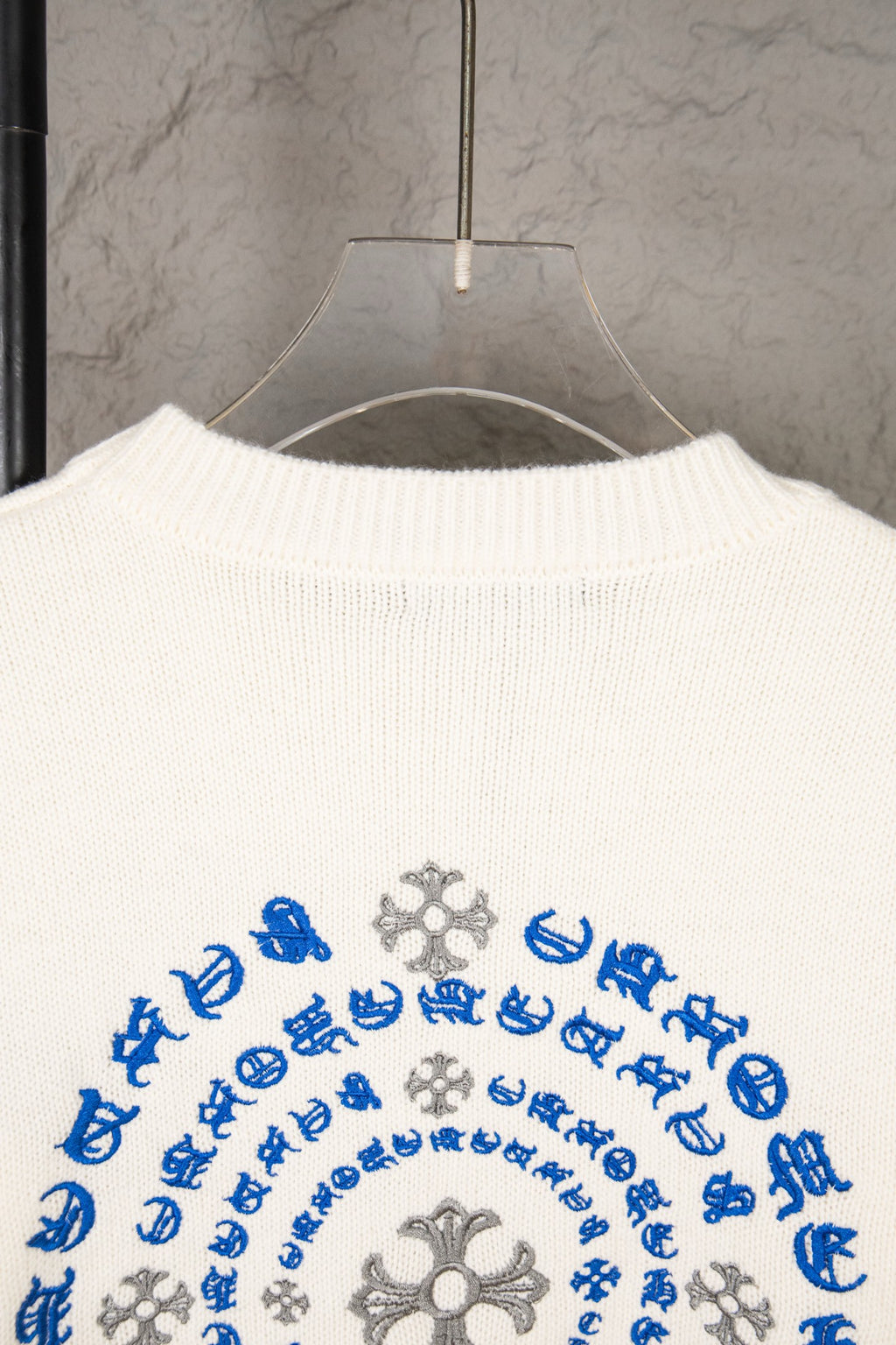 White knit sweater back with large circular blue and gray design